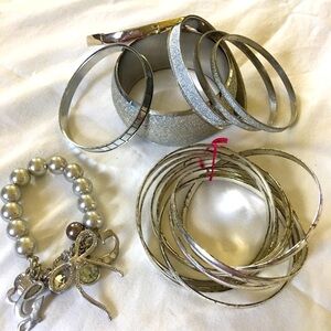 Assorted 11 piece silver tones costume jewelry bracelet lot. Vintage to newer.